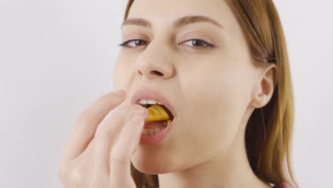 Close-up-of-woman-eating-chips.